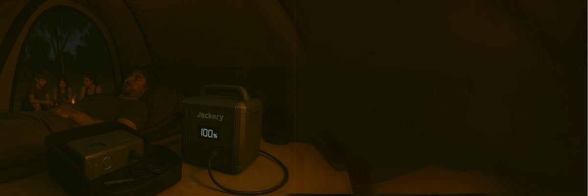 Man sleeping in tent with CPAP machine powered by portable power station at night