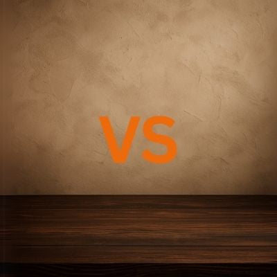 Side-by-side comparison of Bluetti AC70 and AC70P portable power stations on dark wooden table with stucco wall background