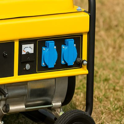 Portable generator outdoors on dry grass in an Australian suburban setting
