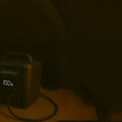 Man sleeping in tent with CPAP machine powered by portable power station at night