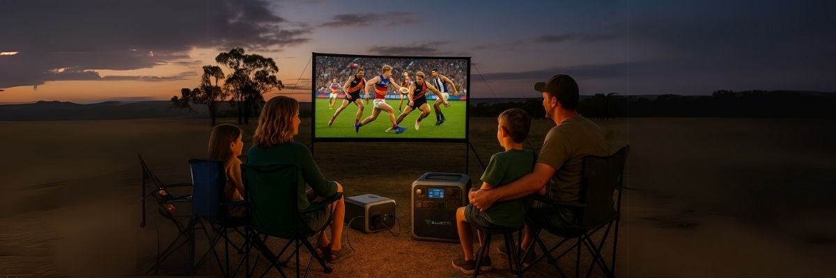 Family watching outdoor sports screen powered by Bluetti power station