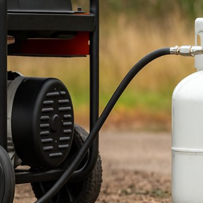 Portable propane generator connected to a propane cylinder outdoors on a wide background scene.