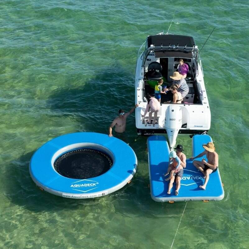 AquaDeck inflatable U-shaped pontoon with roller bag and pump attached to outboard boat