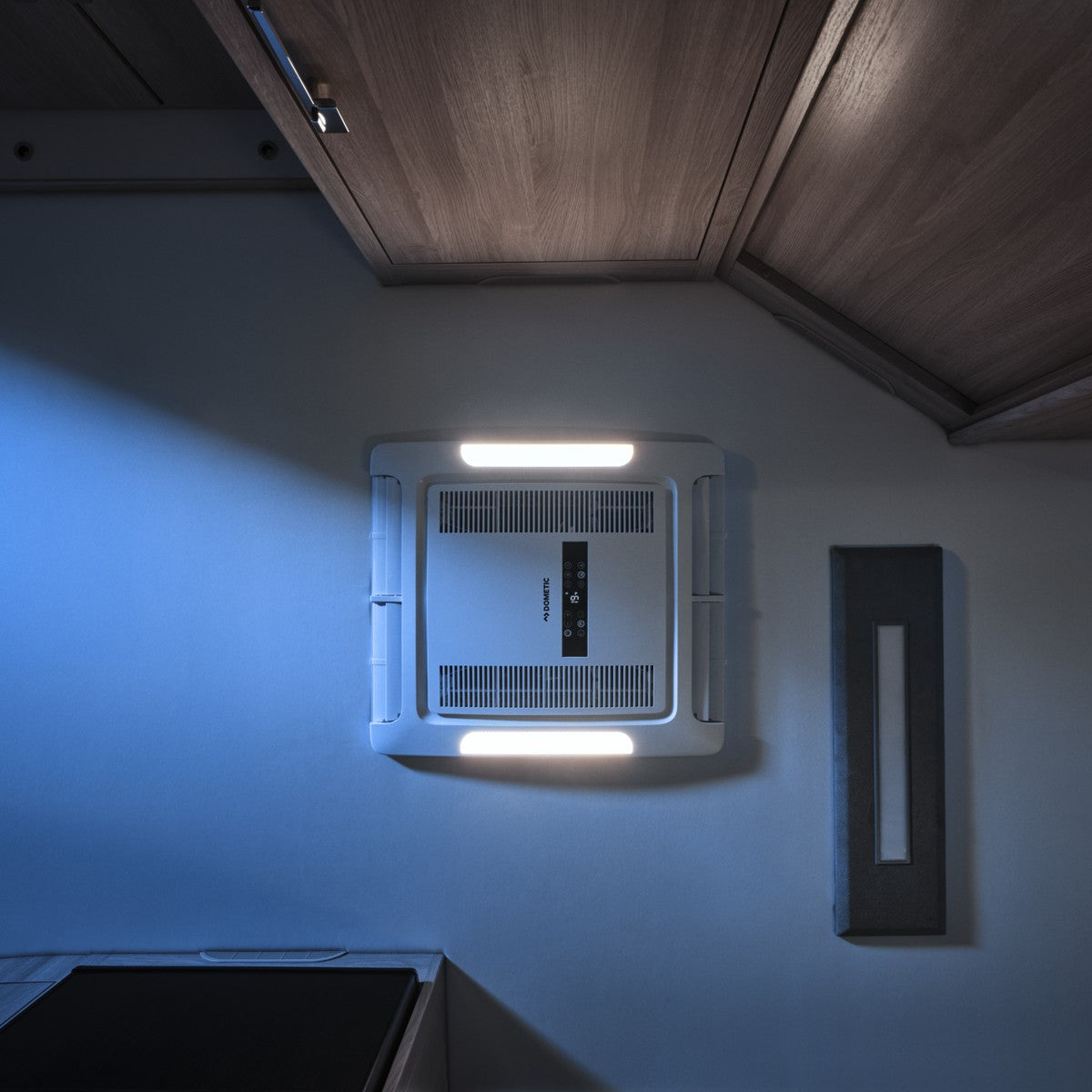 FreshJet ADB fitted into a caravan ceiling with its LED lights on at night