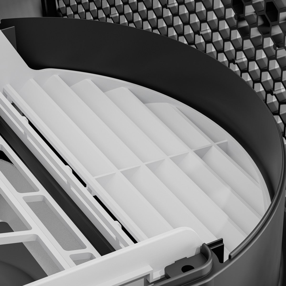 White pleated filter element seated inside the round dust reduction housing