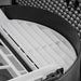 White pleated filter element seated inside the round dust reduction housing