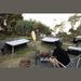 Pico FTC 2x2 swags pitched at a campsite with a bloke cooking at the table