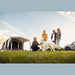 Group with a dog relaxing beside the Santorini FTK 2x4 in a field at sunset