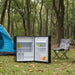 Nova Kool R4509 Fridge open at a camp site with tents in the backghround.