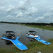 Two boats docked on Aquadeck inflatable Y pontoons in water