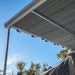 Close-up of Aussie Traveller Anti-Flap Kit PRO+ clamping onto caravan awning fabric edge
