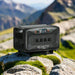 Bluetti Apex 300 portable power station set on rocky terrain in a mountain landscape, showcasing off-grid capability