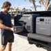 Man inserting Bluetti B70 battery into MultiCooler on ute tray