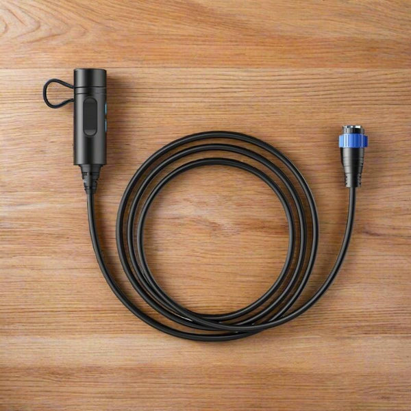 Bluetti P090D battery cable with aviation plug coiled on a table.