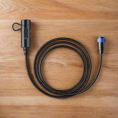 Bluetti P090D battery cable with aviation plug coiled on a table.