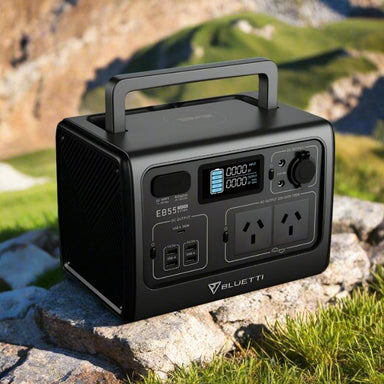Bluetti EB55 power station with handle shown on rocky terrain.