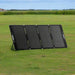 Bluetti MP200 foldable solar panel set up on grassy field.