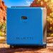 Bluetti RV5 power hub in a red rock gorge with terracotta cliff walls rising behind it