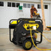 Champion 12500W generator powering tools on jobsite construction crew garage setting