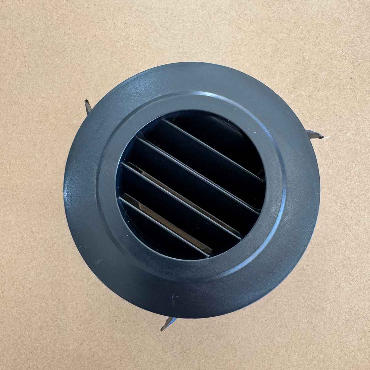 Black round air outlet vent from the Cool-J ducting kit, front view