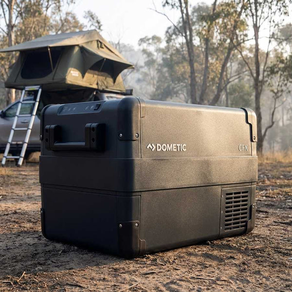 Dometic CFX2 37 portable fridge freezer at a bush camp under a rooftop tent in soft morning light