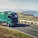 Prime mover on a coastal highway with a Dometic CoolAir RTX parking cooler mounted on the sleeper cab roof