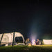Dometic Santorini FTK 2x4 TC lit from inside at night with a campfire and a second tent alongside