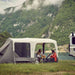 Dometic Santorini FTK 4x8 TC pitched beside a 4WD at a lakeside campsite with the canopy up and a family eating underneath