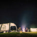 Dometic Santorini FTK 4x8 TC pitched at night under a starry sky with a campfire and a second tent alongside