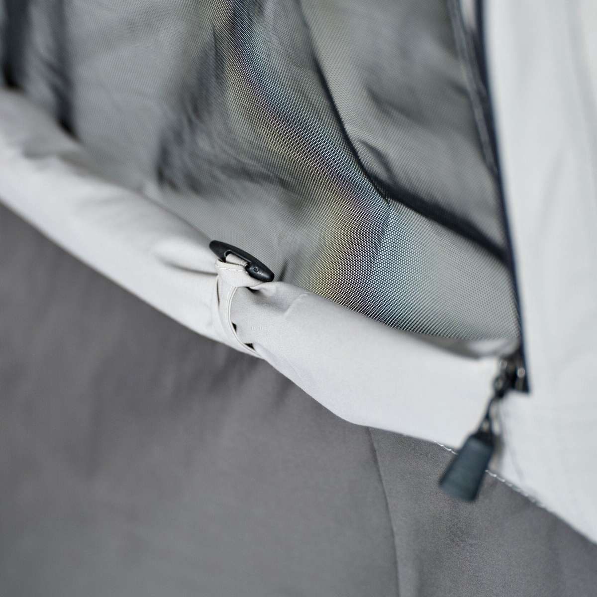 Close-up of the toggle and zip pull on the sidewall panel edge