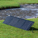 EcoFlow 110W Solar Panel propped up near a river generating power