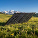 EcoFlow 400W Lightweight Bifacial solar panel set up in an alpine meadow with snow-capped mountains in the background