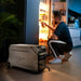 Man kneeling in kitchen at night using fridge powered by EcoFlow DELTA Pro