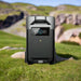 EcoFlow DELTA Pro Smart Extra Battery standing on grass with rocky hills in background