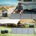 EcoFlow solar panel in use at a campsite with a power station and caravan.