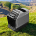 EcoFlow WAVE 3 Portable Air Conditioner set up outdoors on grass with mountains in the background, showing its compact and portable design.