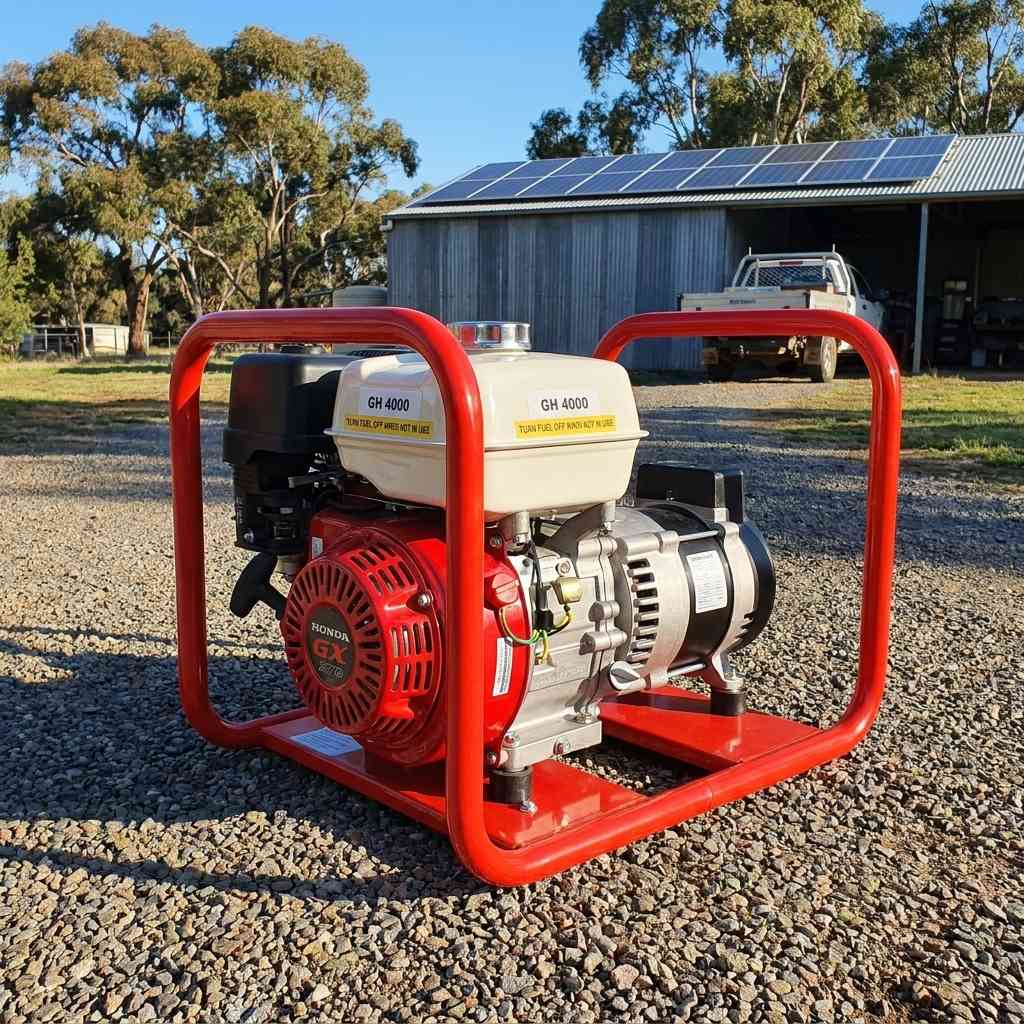 Genelite GH4000-AVR 4.5kVA generator on a gravel driveway at a rural off-grid property with a solar panel array on the shed roof behind