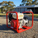 Genelite GH4000-AVR 4.5kVA generator on a gravel driveway at a rural off-grid property with a solar panel array on the shed roof behind