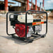 Gentech EP7000HSR generator with Honda GX390 engine, right-angle view on job site