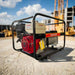 Gentech EP8000HSR generator with Honda GX390 engine and recoil start, angled right at construction site