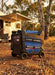 Hyundai HY8000i 10kVA inverter generator centered at an Australian free camp beside a motorhome at golden hour