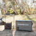 myCOOLMAN 1920Wh power station and fridge set up on the ground at a bush campsite next to a tent