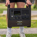 Carrying the myCOOLMAN 1920Wh power station by its handle across a lawn