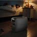 Backup power station running silently beside a sleeping child at night.