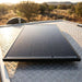 Renogy 120W ShadowFlux solar panel flat-mounted on a camper trailer checker-plate roof
