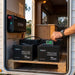 Renogy 15.36kWh off-grid power kit mounted just inside a caravan doorway, four Core Mini batteries and the 3000W inverter installed on a timber shelf