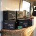 Renogy Core Mini batteries, inverter and battery monitor set up on a van conversion bench beside a kettle and mugs