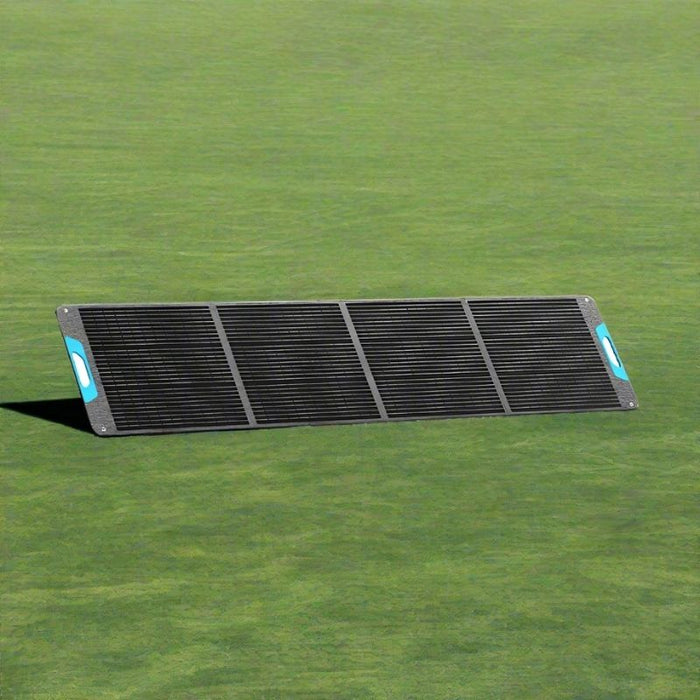 Renogy 200W portable solar panel folded out on grass.
