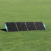 Renogy 200W portable solar panel folded out on grass.