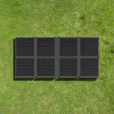 Renogy 200W solar blanket unfolded flat on green grass viewed from above